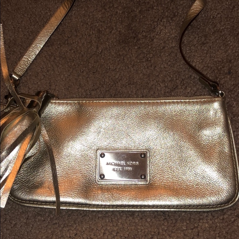 Metallic gold leather wristlet by Michael Kors
